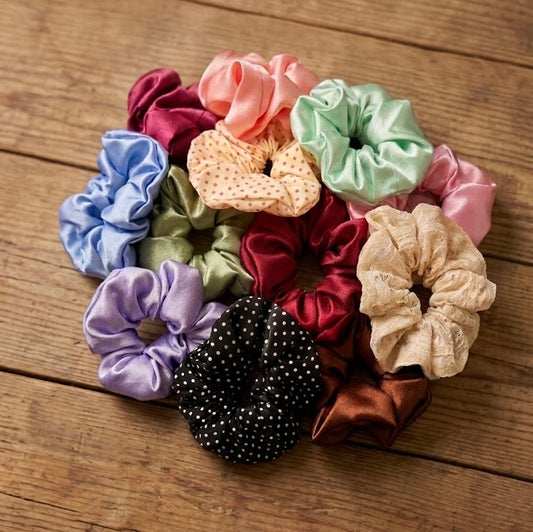 Assorted colorful scrunchies on a wooden surface