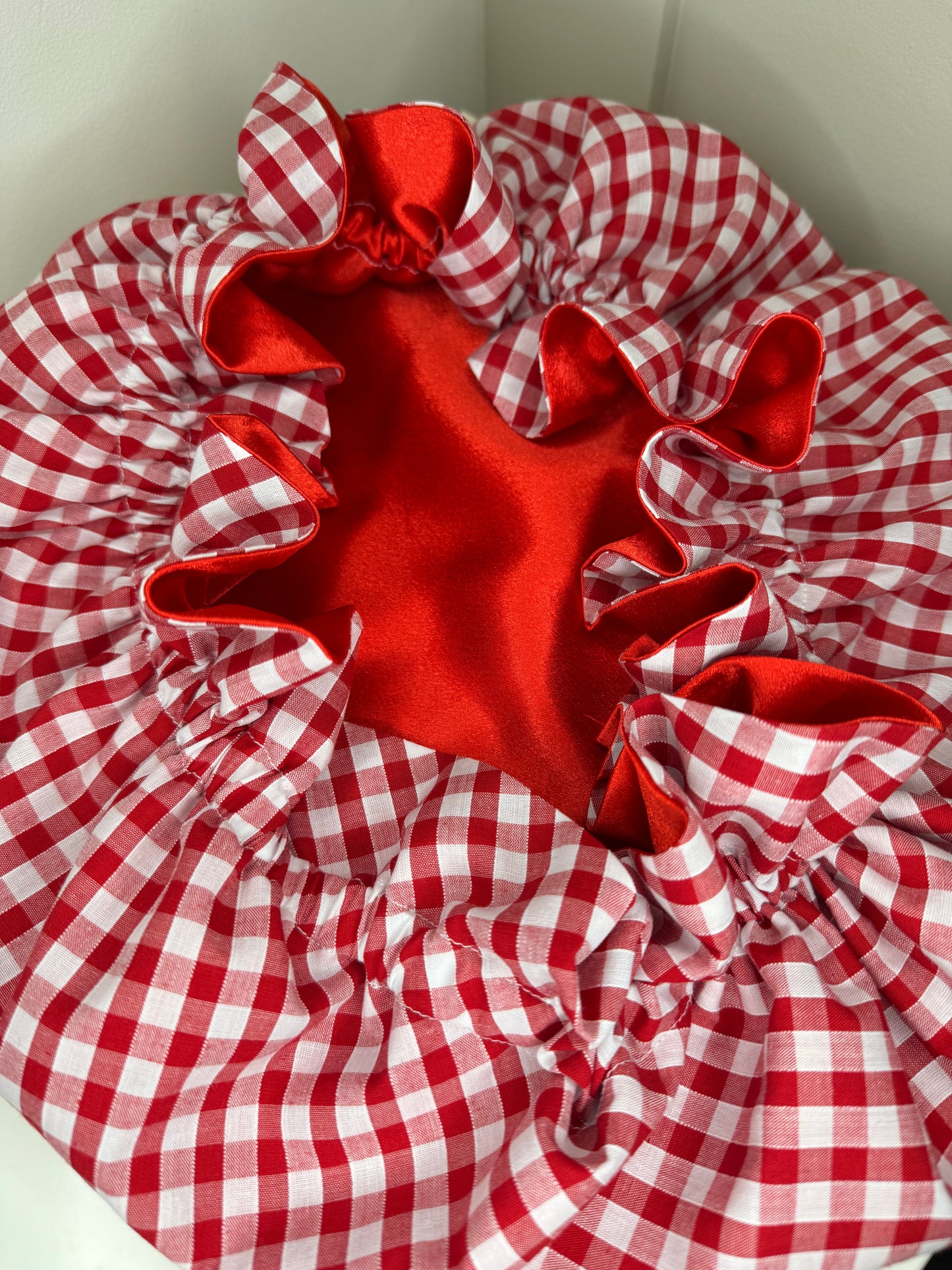 Open checkered red and white satin bonnet open, exposing the deep red satin inside 