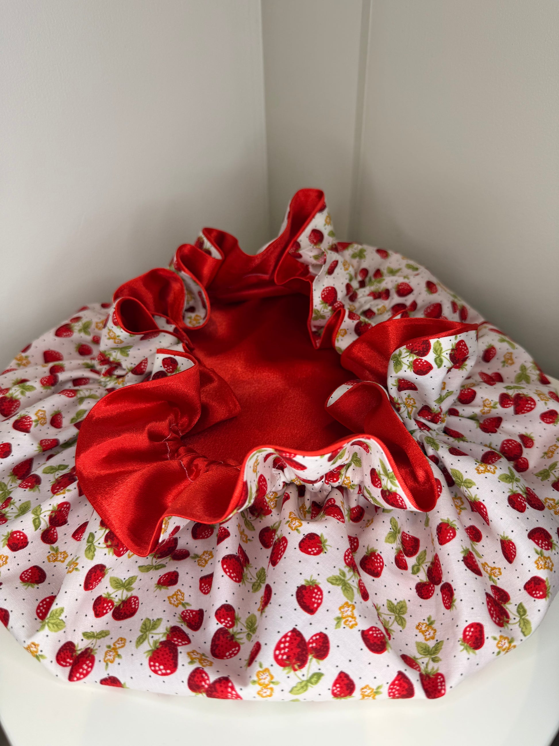 Strawberry design satin bonnet opened and exposed the berry red satin inside 